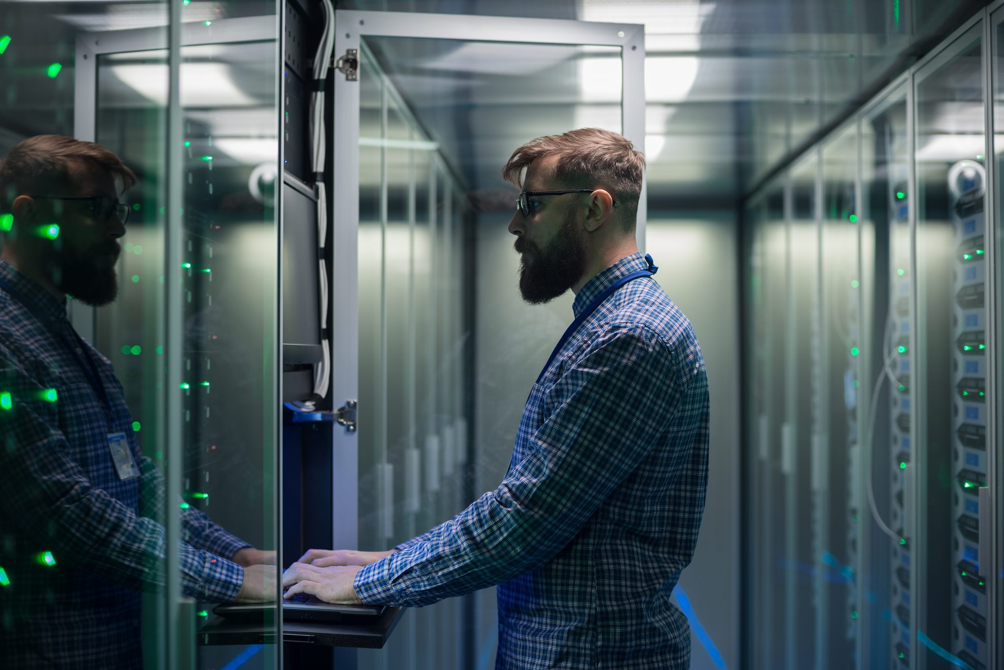 IT specialist setting servers in data center managed it infrastucture engineer