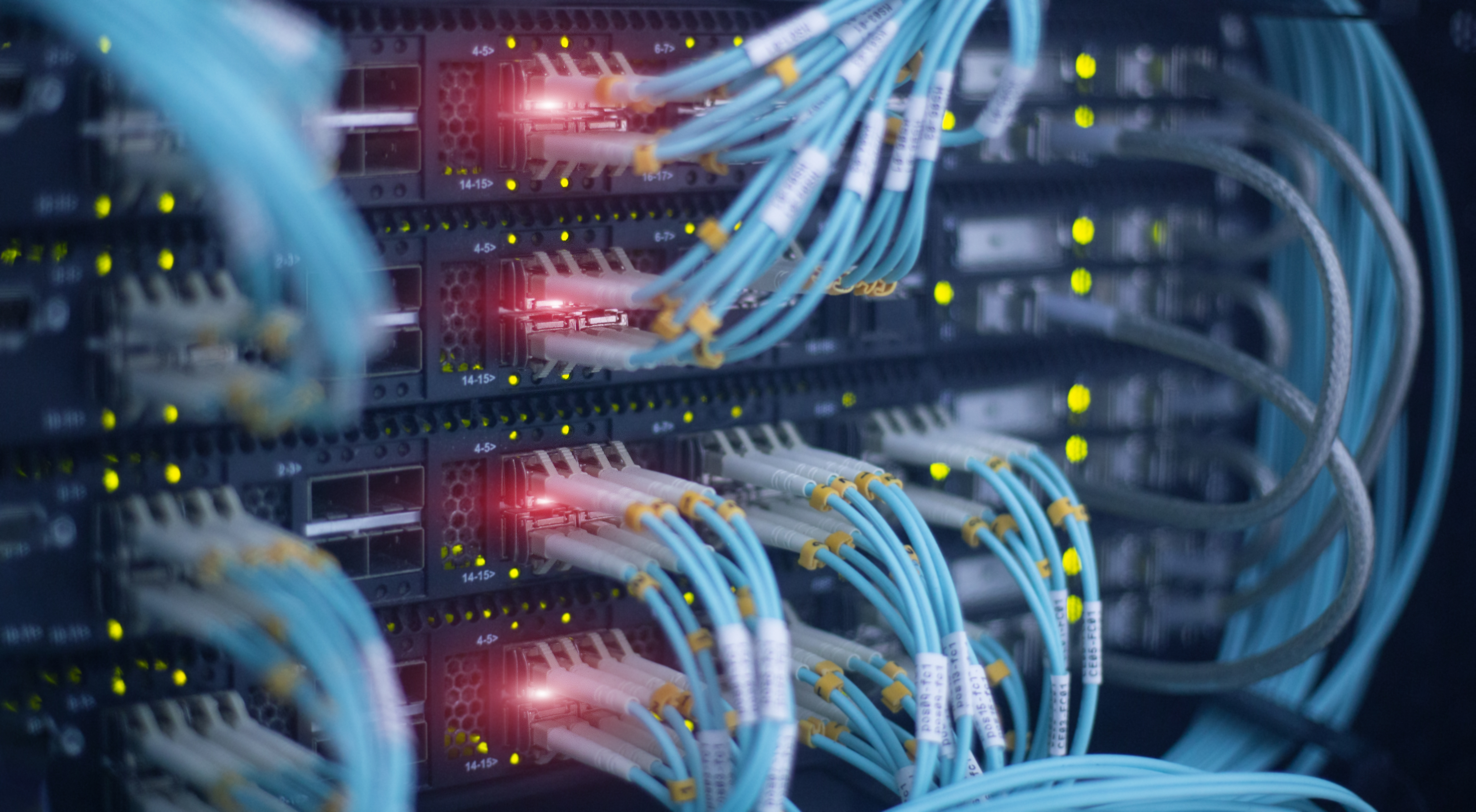Fiber optic and hub. Blue cables and red glow. Fibre Ethernet Leased Lines